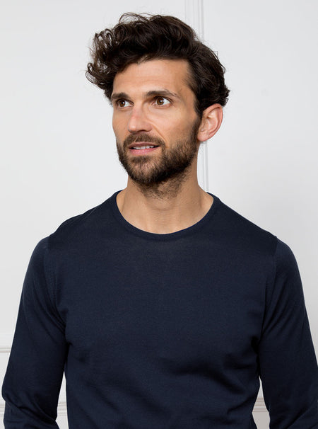 Man wearing midnight blue/grey long sleeved knit in 100% merino wool from New Zealand.
